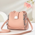 Detail view of pink bucket bag with lychee grain leather and silver hardware accents - Pink