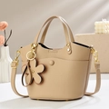 Detailed macro shot of lychee grain leather texture and golden hardware on bucket bag - 20*12*19cm / Apricot