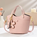 Detail of pink lychee leather bucket bag with floral charm and gold-tone hardware - 20*12*19cm / Pink