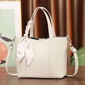Close-up of off-white leather tote bag with printed silk scarf wrapped on the handle - Off White