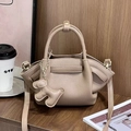 Chic beige lychee leather dumpling handbag with cute bear charm and shoulder strap - Khaki
