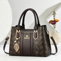 Deep brown monogram handbag with gold brand logo and adjustable shoulder strap - Coffee