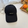 Black cotton baseball cap featuring yellow sheenlines embroidery on a sunny background - Black