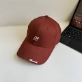 Dark red cotton baseball cap featuring white N embroidery and side script on white desk - 56-60cm Adjustable / Burgundy