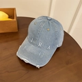 Light blue denim baseball cap with white MIRAC embroidery and distressed brim on a table - 56-59cm (Adjustable) / Denim Blue