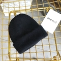 Close-up of soft black Angora knit hat texture on a modern gold mesh chair - Approx 54-58cm (Elastic) / Black