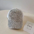 Close-up of sparkling silver rhinestones on the brim and crown of a white mesh trucker hat - Adjustable / White Silver