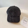 Close-up of black mesh trucker hat featuring shiny rhinestones and sequins on the brim - Adjustable / Black