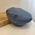 Detail view of the gray-blue vintage beret hat in twill cotton on a wooden tray - 54-58cm (Adjustable) / Denim Blue