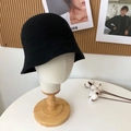 Detailed view of a black wool felt bucket hat on a mannequin head with decorative background - 55-58cm / Black