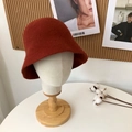 Detail of terracotta wool bucket hat with knitted texture on a minimalist display stand - 55-58cm / Caramel color