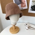 Detail of warm brown wool bucket hat showing soft knitted texture on display stand - 55-58cm / Brown