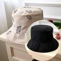 Detail of reversible bucket hats in black and beige with butterfly pattern embroidery - Beige