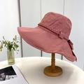 Detailed shot of pink striped sun hat with wide brim and woven ribbon on wooden stand - 55-59CM / Pink