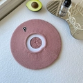 Detail of pink knitted beret featuring a black letter P patch on soft wool texture - One Size / Pink