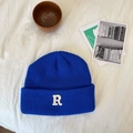 Detail van een kobaltblauw gebreide muts met een witte geborduurde letter R patch - 55-60cm / Saffierblauw