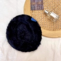 Detail of black faux rabbit fur beret with a small blue heart patch on soft fabric - 55-58cm / Black