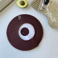 Detail of dark brown knitted beret with embroidered letter P patch and ribbed texture - One Size / Coffee