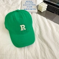 Close-up of a green baseball cap with white letter R embroidery on a clean desk - 55-59cm (Adjustable) / Bright Green
