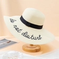Detail of beach straw hat featuring 'do not disturb' embroidery and a black ribbon band - 55-59CM / Off-white