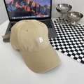 Detail view of khaki cotton baseball cap with white letter B embroidery on a desk - Large Size Adjustable / Khaki