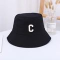 Unisex black canvas bucket hat with white embroidered C letter on a minimalist desk - 55-59CM / Black
