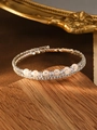 Macro view of multi-layer silver bangle with white pearls and sparkling cubic zirconia stones - Silver (Six Pearls)