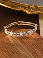 Detail of silver double-layer bracelet with white zircons on vintage wooden surface - Silver (Square Zirconia)
