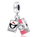 Detailed close-up of a silver camera charm and photo pendant with pink enamel - Pink Camera and Instant Photo Style