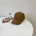 Brown nylon ponytail baseball cap with a round metal KT logo on a white table - 56-60cm (Adjustable) / Brown