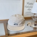 Off-white five-panel camper hat with mountain magic club patch on wooden glass display - 56-58cm / Beige Khaki