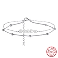 Macro detail of S925 sterling silver double layer anklet with pearls and lobster clasp - 925 Sterling Silver/Natural Freshwater Pearl / White Gold