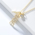 Macro detail of gold S925 silver necklace with LOVE charm and crystal pendants - 925 Silver / Gold