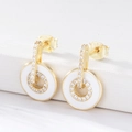 Macro shot of S925 sterling silver stamp on golden enamel earrings with cubic zirconia - 925 Silver / White