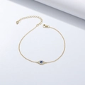 Bracciale dorato occhio del malocchio con micro zirconi e pietra blu su sfondo bianco - Argento 925 / Giallo