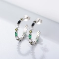Macro shot of silver C-shaped hoops featuring vibrant colorful zircon marquise stones - 925 Silver / White