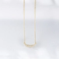 Detailed close-up of golden angel wing pendant with micro-pave cubic zirconia on silk fabric - 925 Silver / Yellow
