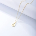 Detail of gold starburst square pendant necklace with a sparkling center zircon stone - 925 Silver / Yellow