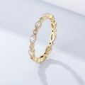 Macro detail of gold eternity ring with marquise and round stones and milgrain edges - US 5 / Gold