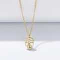 Detailed macro view of gold-tone skull pendant necklace encrusted with sparkling zircons - 925 Silver / Gold