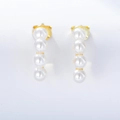 Elegant gold drop earrings featuring four white pearls in vertical alignment on white background - 925 Silver / Gold