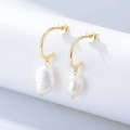 Golden S925 silver C-shaped earrings with natural baroque pearls on a white display - 925 Silver / Gold