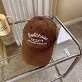 Brown corduroy baseball cap with white embroidery displayed on a glass table - 56-58cm Adjustable / Coffee