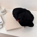Black cotton newsboy cap with red and white felt button details on a white book - 56-60cm (Elastic) / Black