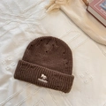 Dark coffee knit beanie with fox embroidery and distressed details on a white surface - Brown