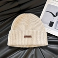 Beige knitted beanie with leather label on black leather background for winter style - 56-62cm / Beige (Letter P)