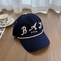 Navy blue baseball cap with white BAD embroidery and decorative rope trim on a wood floor - 56-58cm Adjustable / Navy Blue