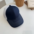 Navy blue and white mesh trucker hat with curved brim in a casual outdoor setting - 56-58cm Adjustable / Navy Blue