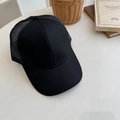 Classic black trucker hat with mesh back and curved brim on a minimalist white table - 56-58cm Adjustable / Black/Black Mesh
