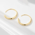 Close-up of 18K gold hoop earrings with gradient thickness on a white background - 925 Silver / Gold